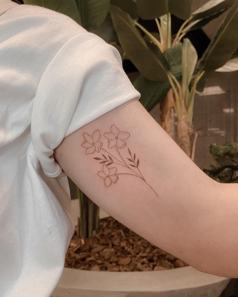 A fine-line floral tattoo, single-needle style