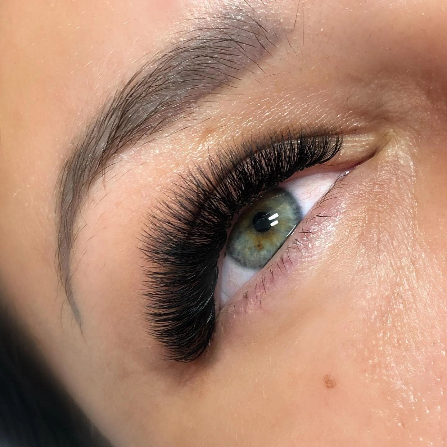 A volume lash set — handmade fans giving a full, dark lash line